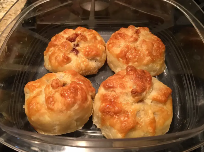 Golden-brown individual apple pie dump cakes baked to perfection in a glass dish